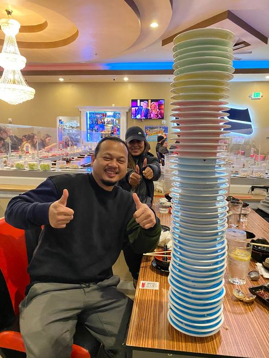 two patrons delight in their meal at the hot pot world rotary restaurant,savoring the unique dining experience together
